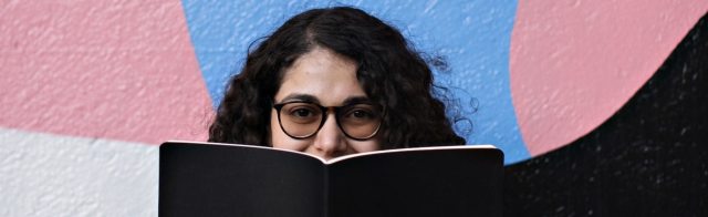 A student holding a textbook