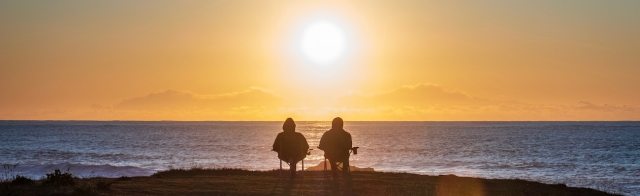 A couple sitting near a beach