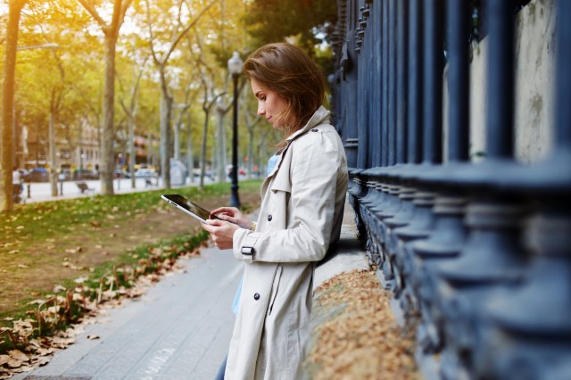 Woman accessing online banking app on a tablet