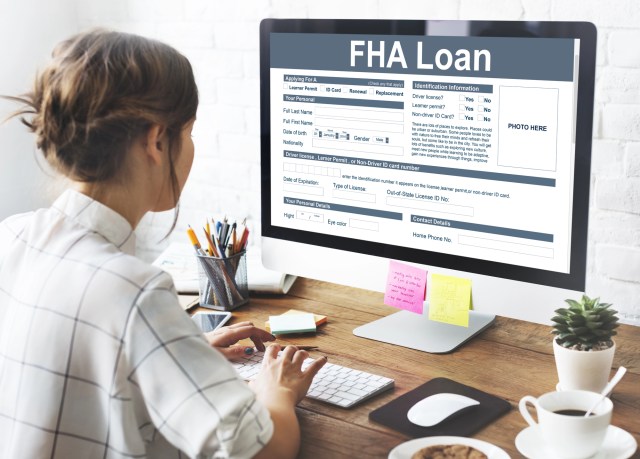 Woman applying for FHA loan on desktop computer