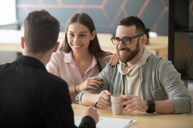 Couple meeting with banker behind desk