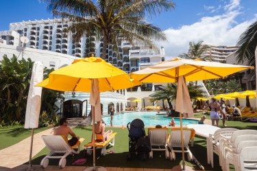 Resort-style swimming pool with lounge chairs and umbrellas at a vacation property commonly associated with timeshare ownership